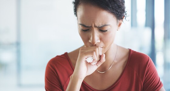 A picture of a woman coughing A picture of a woman coughing