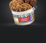 Bucket of cookies on black background
