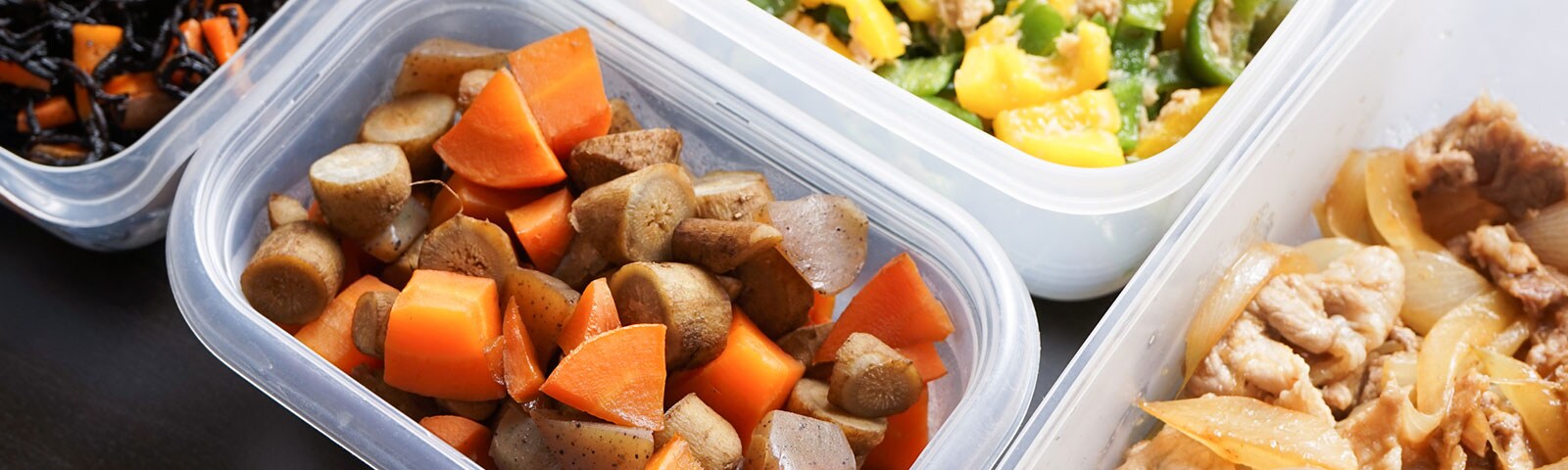 Multiple plastic food containers full of various chopped vegetables Multiple plastic food containers full of various chopped vegetables