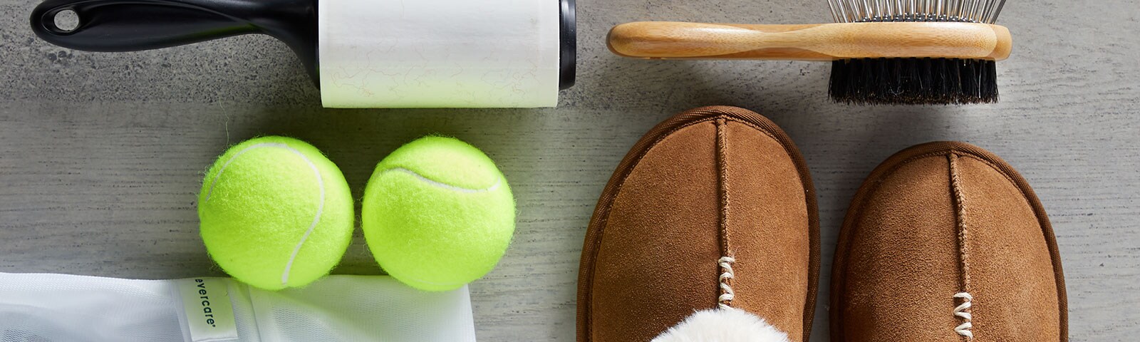 A pair of slippers, tennis balls, lent roller, and brush to take care of your wardrobe