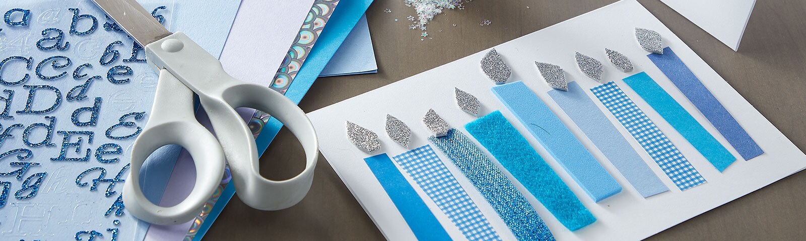 White and blue colored paper in shapes of candles and cards White and blue colored paper in shapes of candles and cards