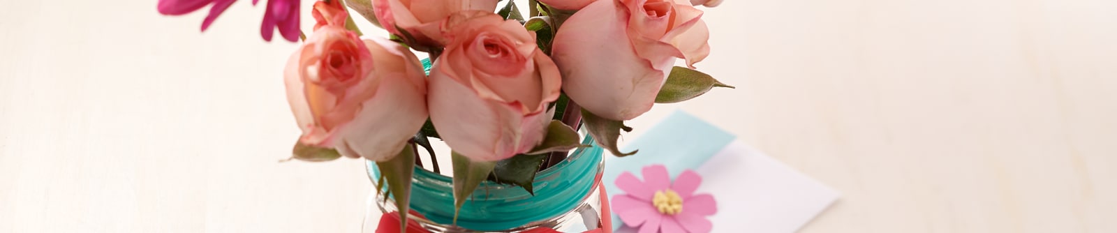 Decorated mason jar filled with pale pink roses Decorated mason jar filled with pale pink roses