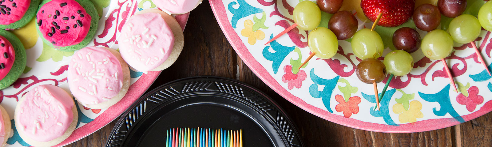 Cookies and fruits on colorful paper plates Cookies and fruits on colorful paper plates