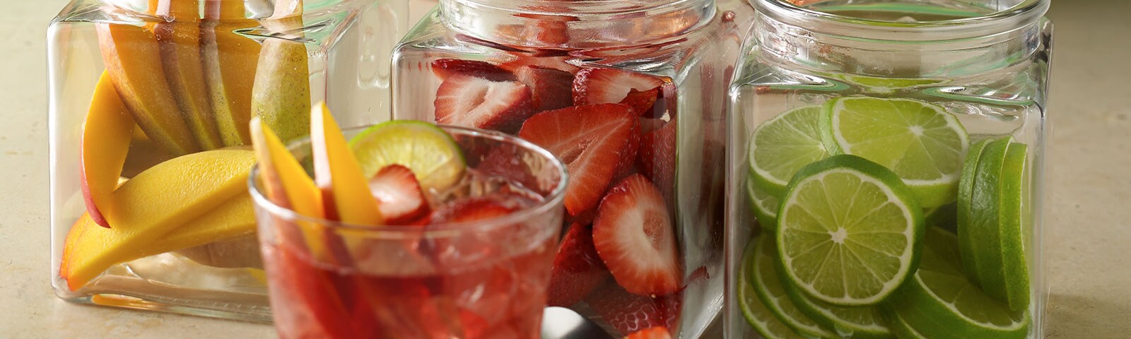 Strawberries and lime in a glass with ice Strawberries and lime in a glass with ice