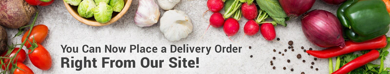 Online grocery delivery text in front of fresh produce scattered on table. Online grocery delivery text in front of fresh produce scattered on table.